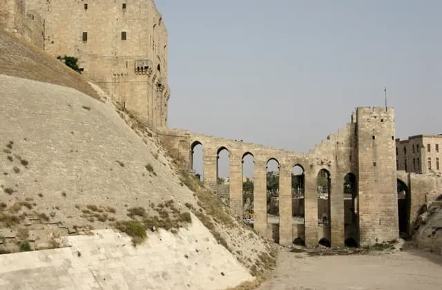 Archive view of the Citadel of Aleppo stone-faced slope and arched entrance bridge, photographed by Vyacheslav Argenberg on 21 August 2008.