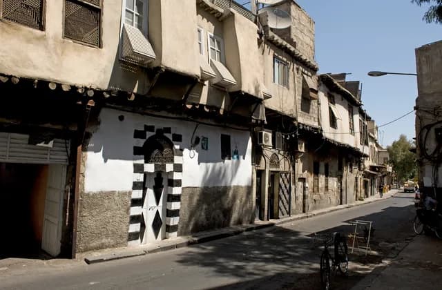 Older street frontages and a striped doorway on Badawi street in Damascus, September 2008