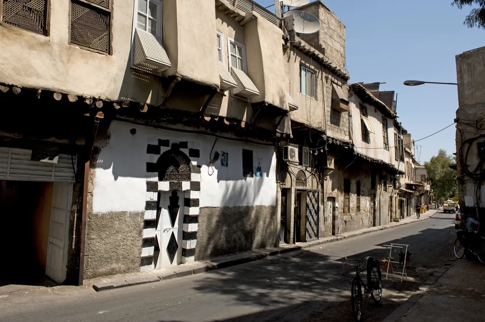 Older street frontages and a striped doorway on Badawi street in Damascus, September 2008