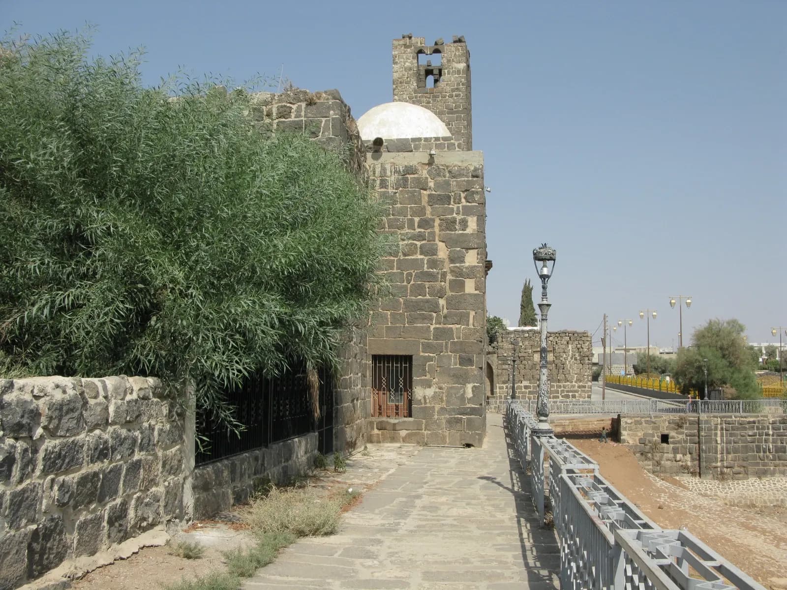 Stone walls beside a paved passage at Bosra in Daraa, August 2008