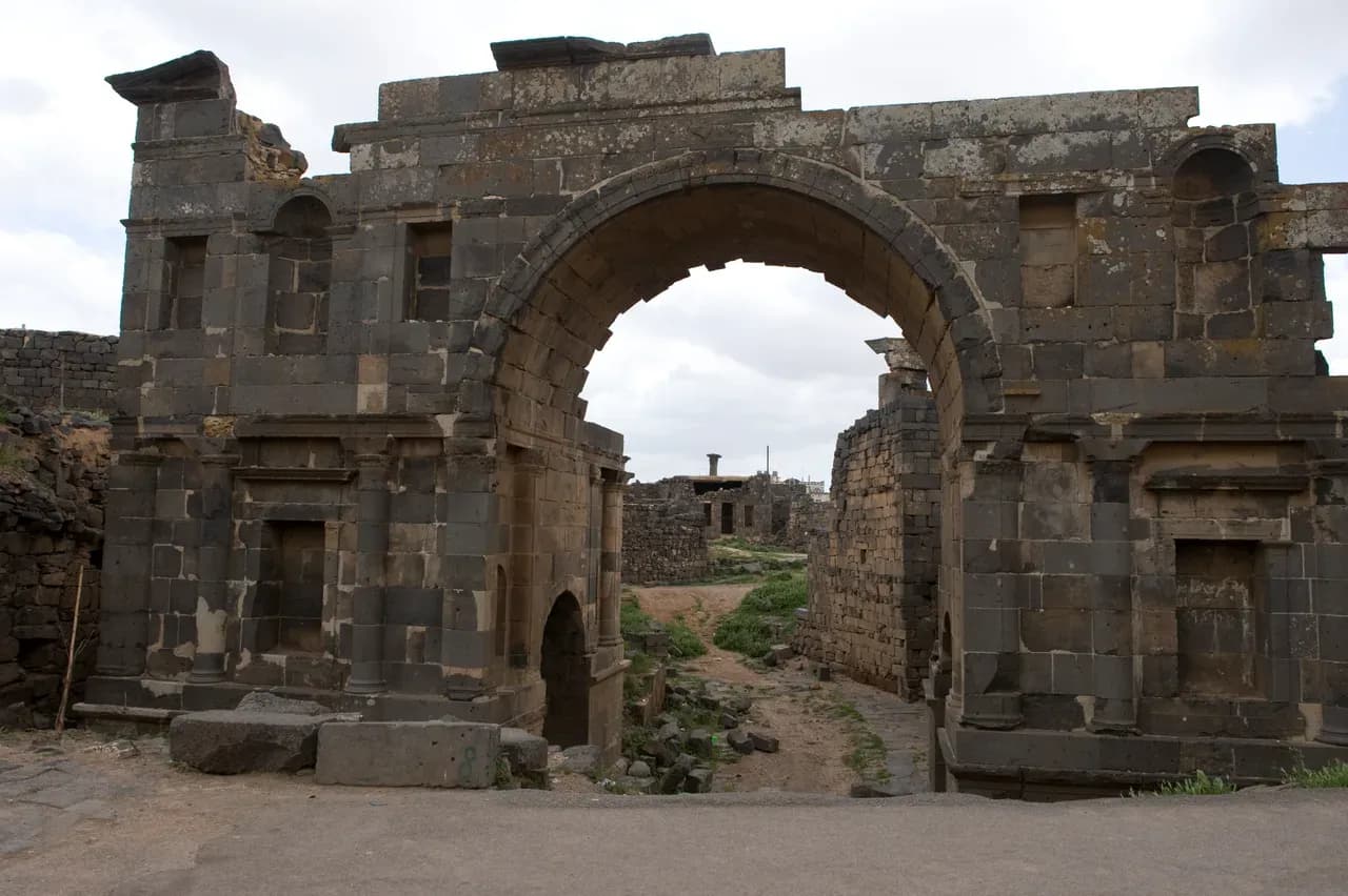 Stone East or Nabataean Gate on an old-city street in Bosra, photographed by Dosseman in April 2009.