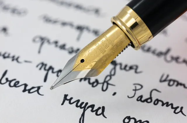 Close view of a fountain-pen nib above handwritten Cyrillic words, photographed in January 2017