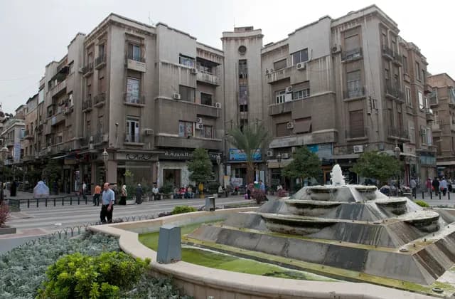 Fountain and balconied buildings around al-Hariqah Square in Damascus, photographed in September 2010