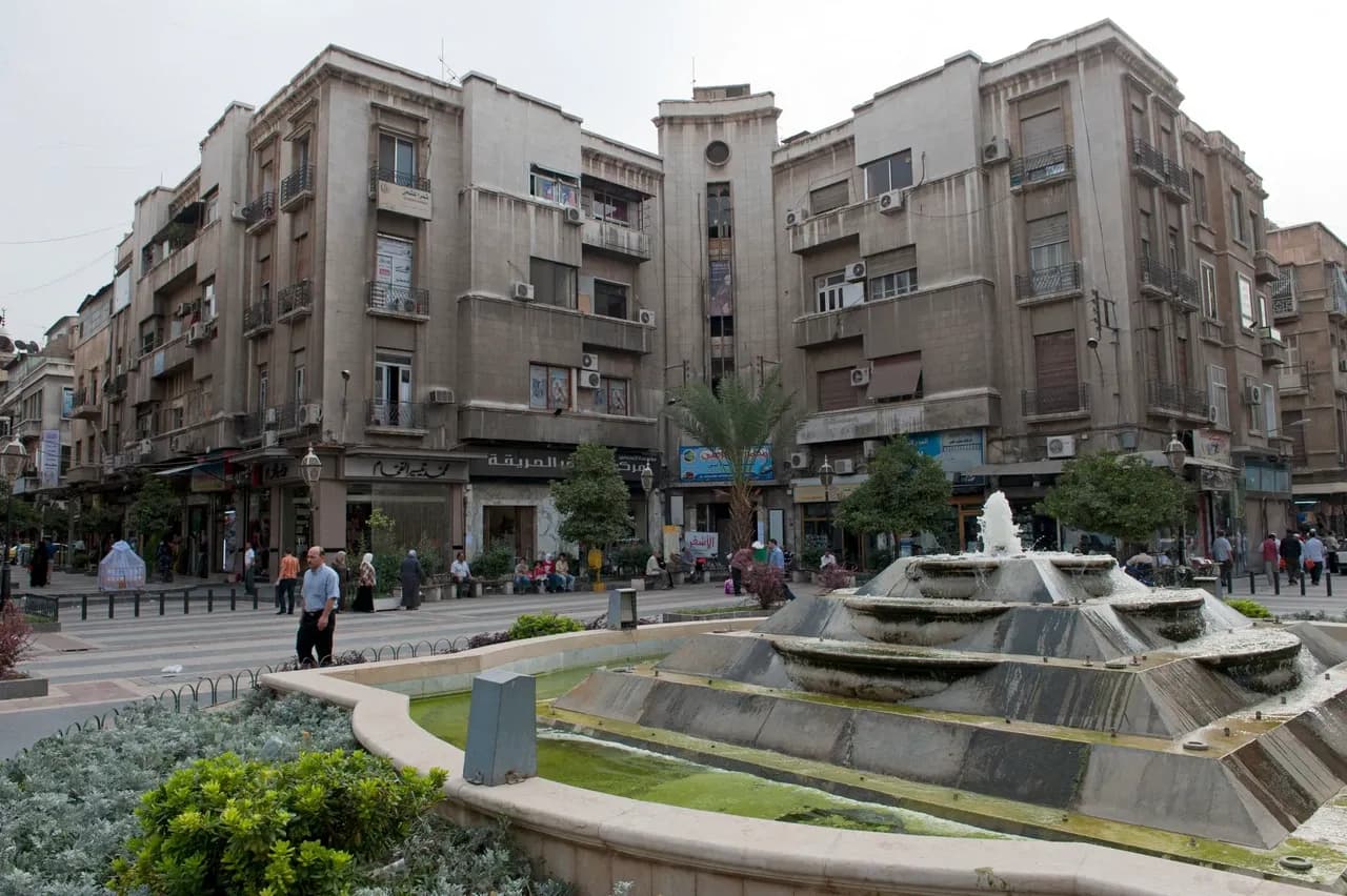 Fountain and balconied buildings around al-Hariqah Square in Damascus, photographed in September 2010