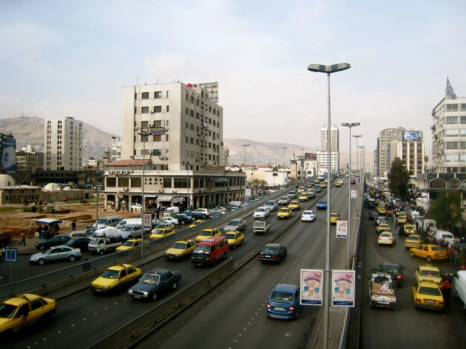 Central Damascus road and flyover with buildings and Mount Qasioun in the background, archive 2009