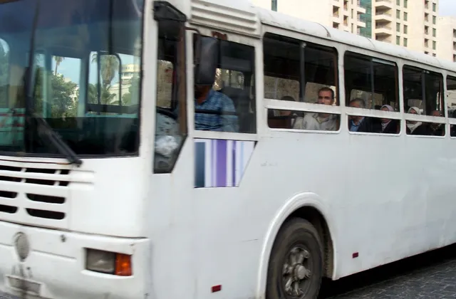 White passenger bus on a street in Damascus, archive 2009