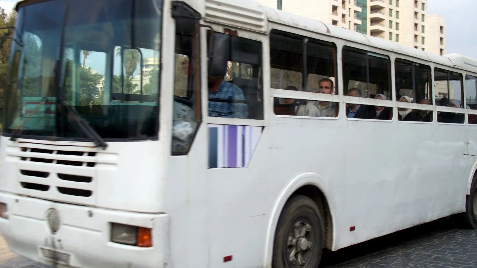 White passenger bus on a street in Damascus, archive 2009