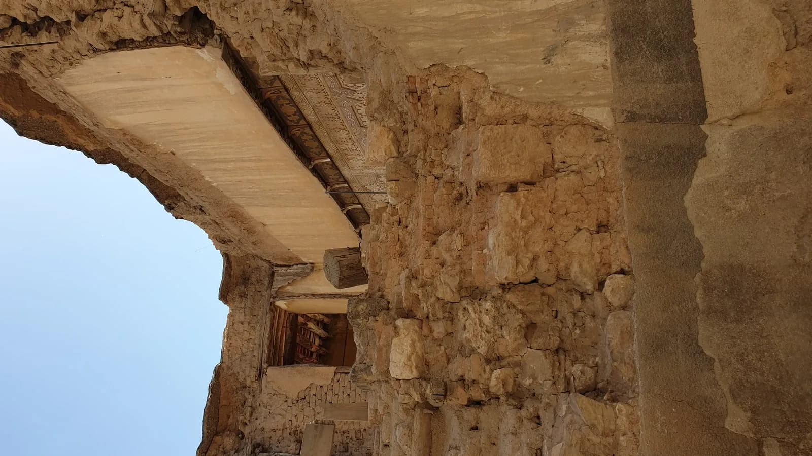 Exposed masonry and a decorated building underside in Old Damascus, September 2021