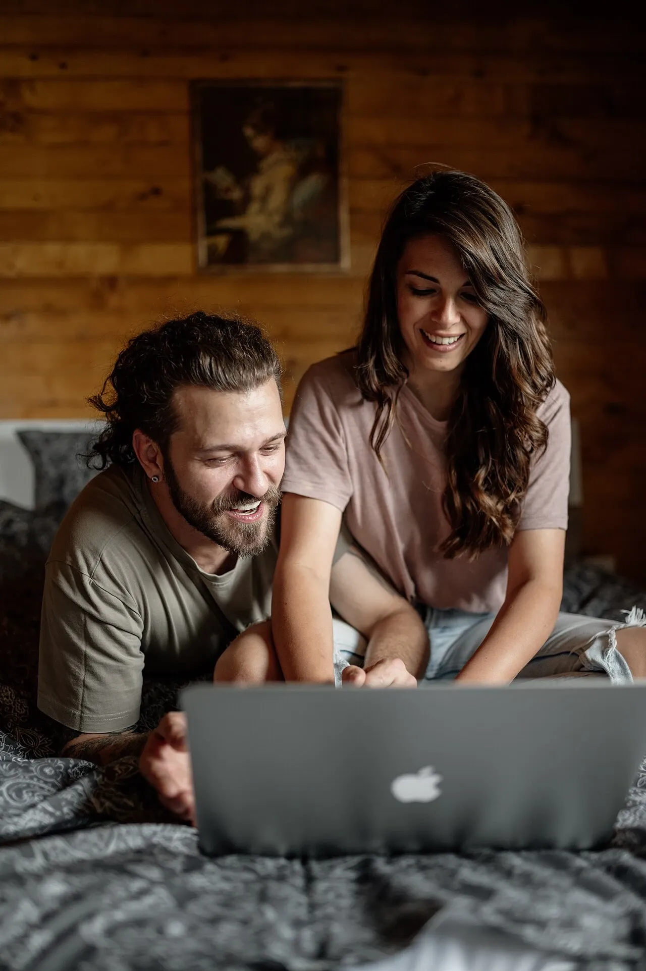 Two people seated together using a laptop, May 2024 illustrative photograph