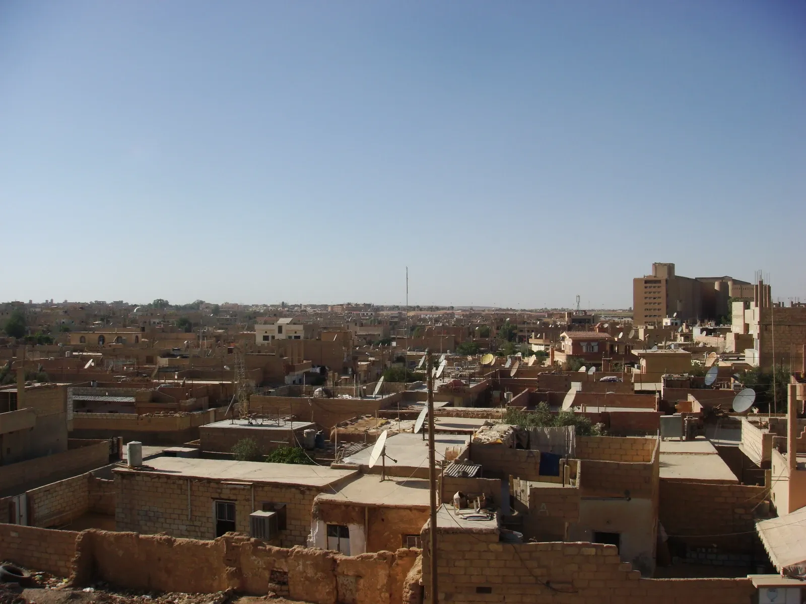 Elevated view across adjoining roofs and satellite dishes in Tal Hajar quarter, Al-Hasakah, in 2009
