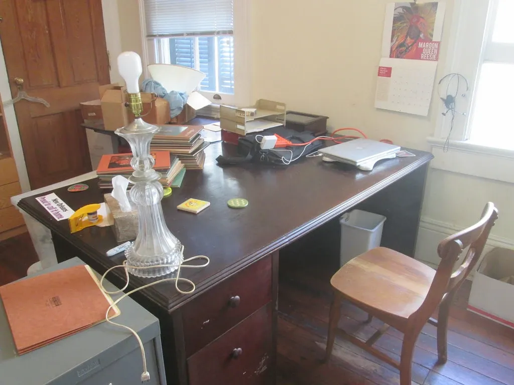 Large wooden desk and chair occupying a home office beside windows in Carrollton, New Orleans, February 2016