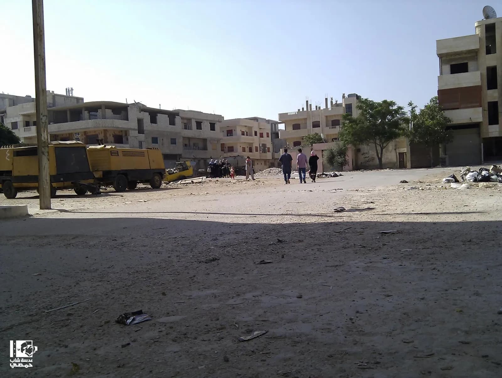 Buildings, pedestrians and a street in Al-Shammas, Homs, archive uploaded in 2012