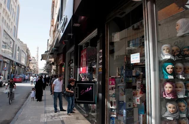 Shopfronts and pedestrians on a Homs street, October 2010