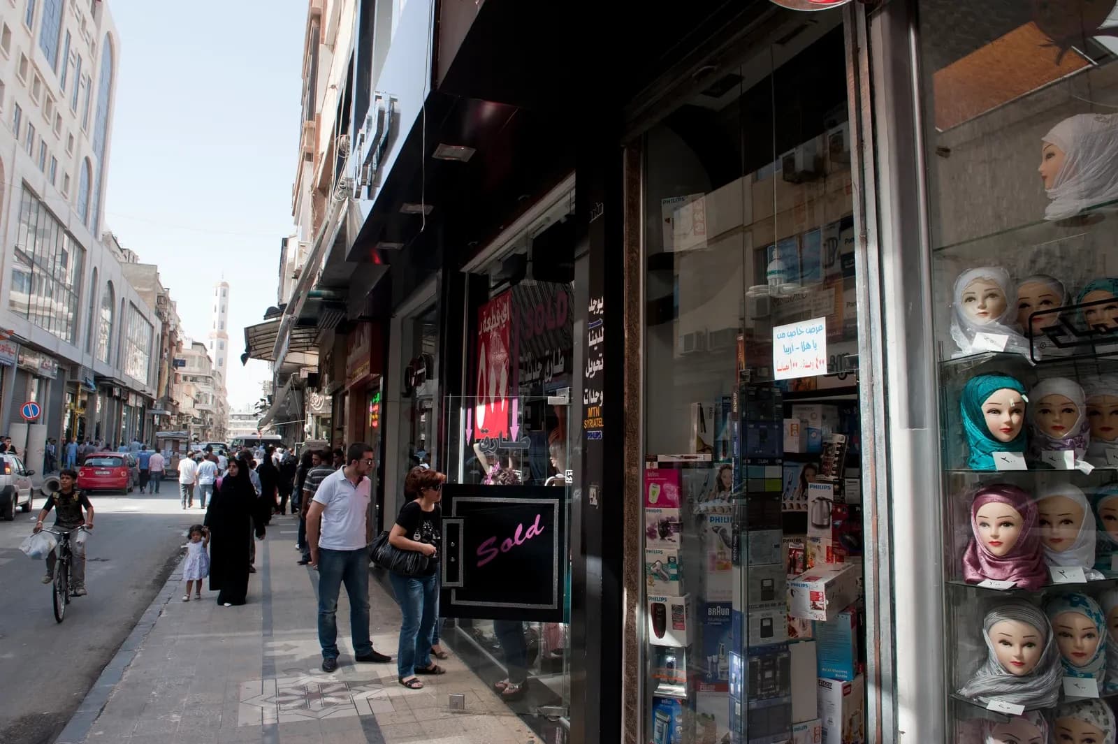 Shopfronts and pedestrians on a Homs street, October 2010