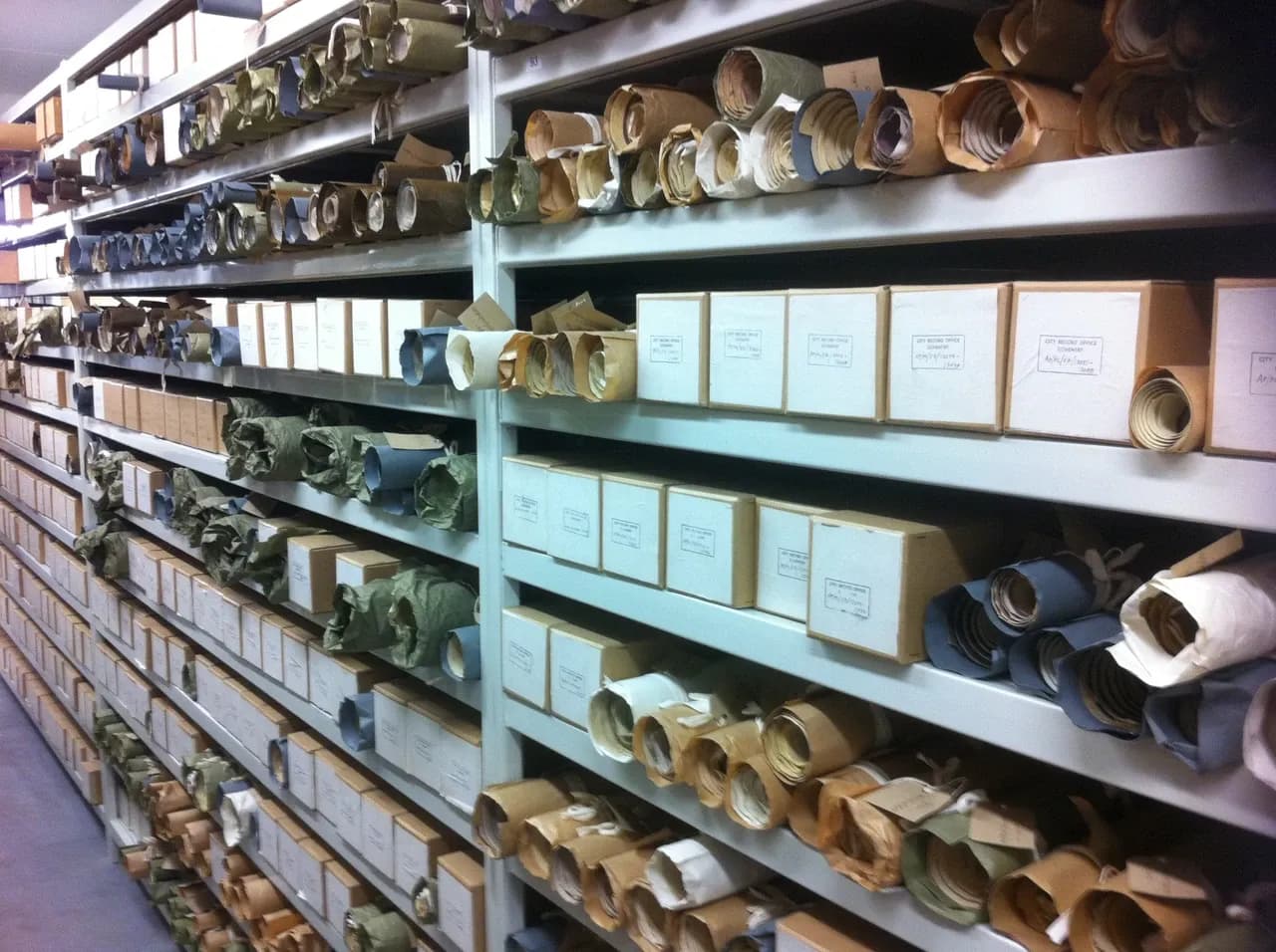 Rolled papers and labelled boxes on archive shelves at the Herbert History Centre in Coventry, photographed in October 2011