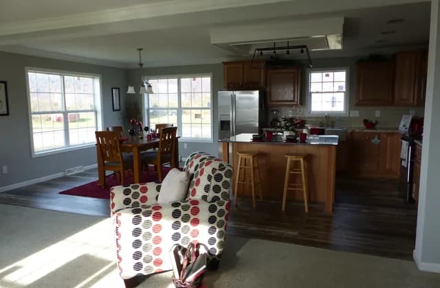 Furnished display-home kitchen with cabinets, an island, stools and a dining table, photographed in November 2018