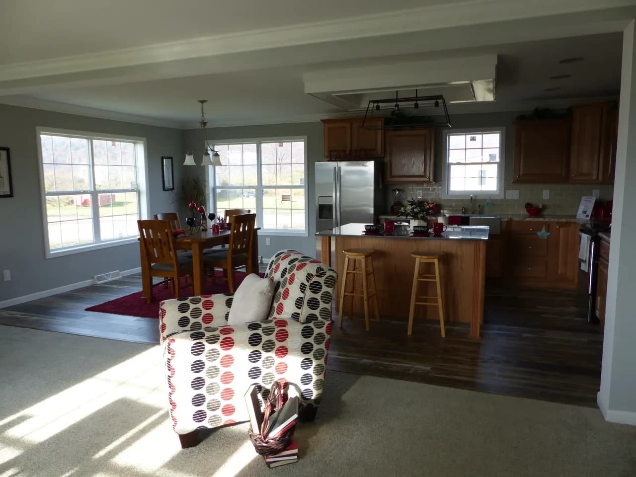 Furnished display-home kitchen with cabinets, an island, stools and a dining table, photographed in November 2018