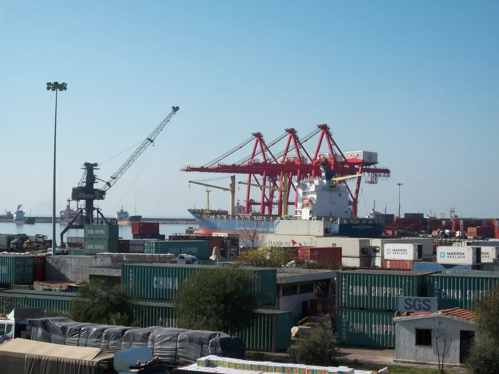 Ship, red gantry cranes and container stacks at Latakia harbour, June 2008