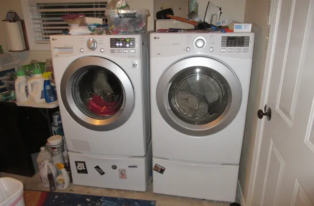 Washer and dryer beside an open door and household supplies in Louisiana, photographed in October 2017