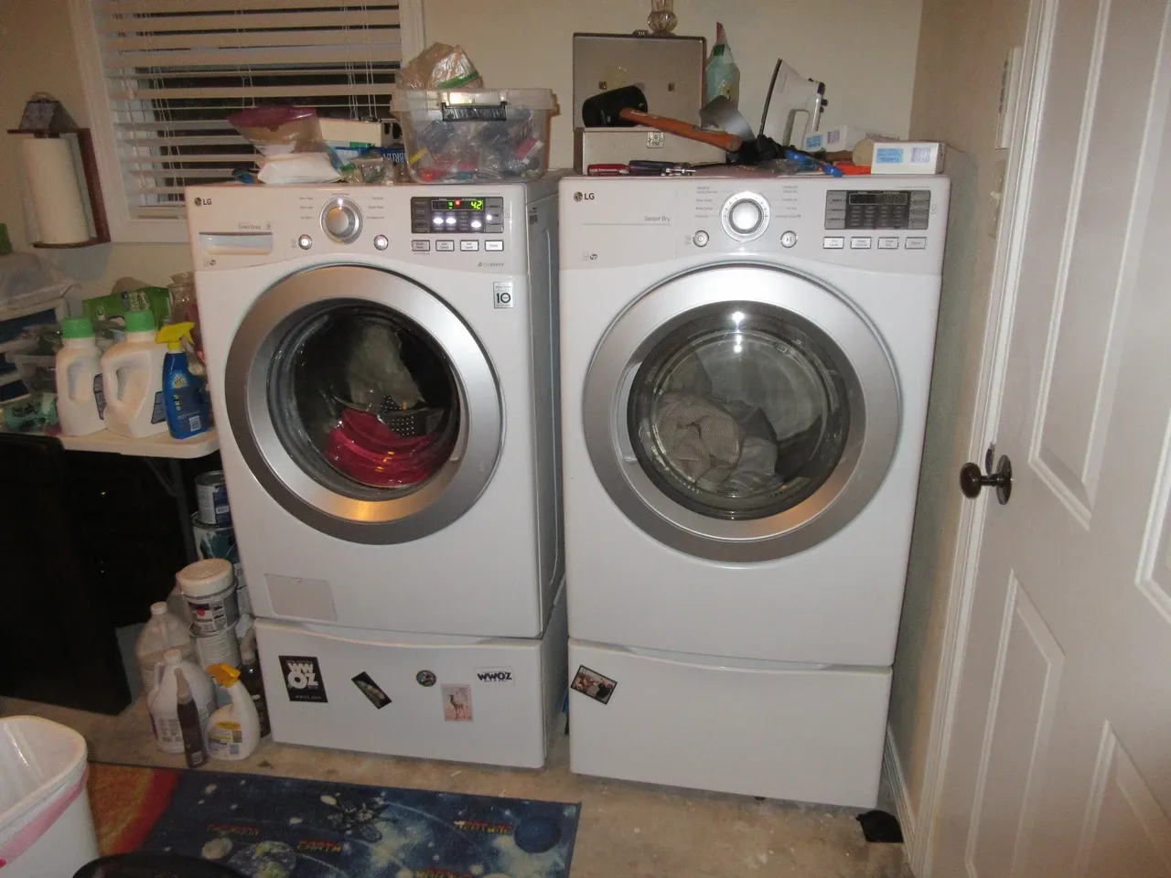 Washer and dryer beside an open door and household supplies in Louisiana, photographed in October 2017