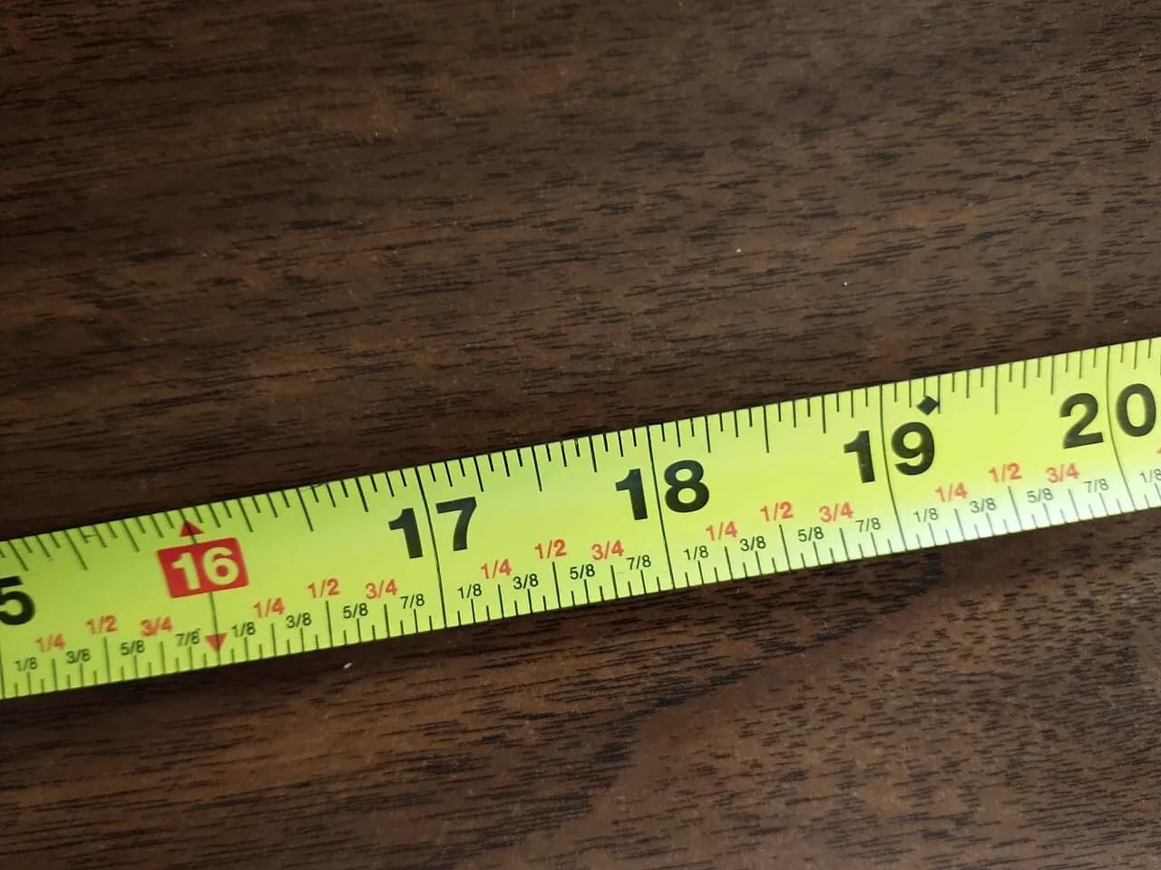Close view of an extended measuring tape with inch markings