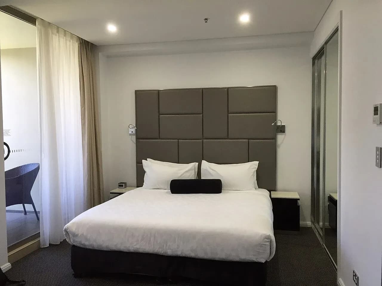 Bed and curtains in serviced accommodation in North Ryde, Australia