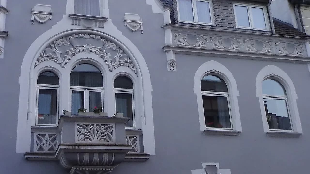 Upper windows and balcony of a residential facade in Bad Honnef, Germany