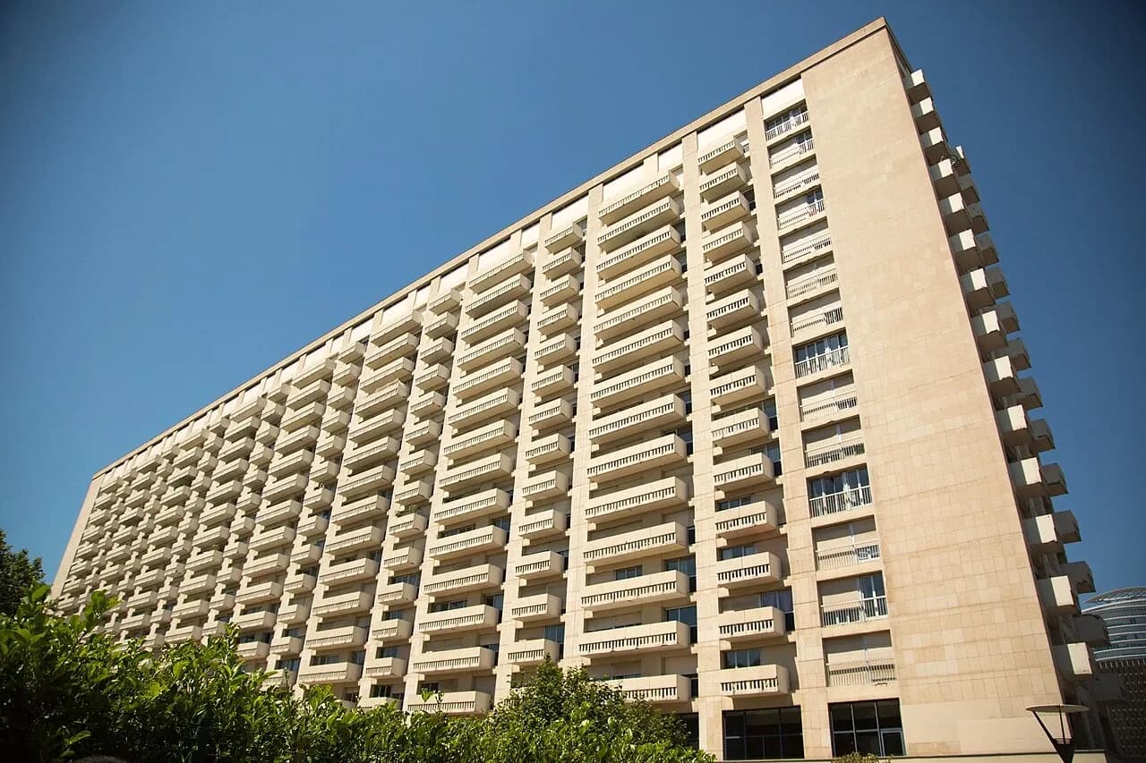 Long apartment building facade with repeated balconies in Lyon, France