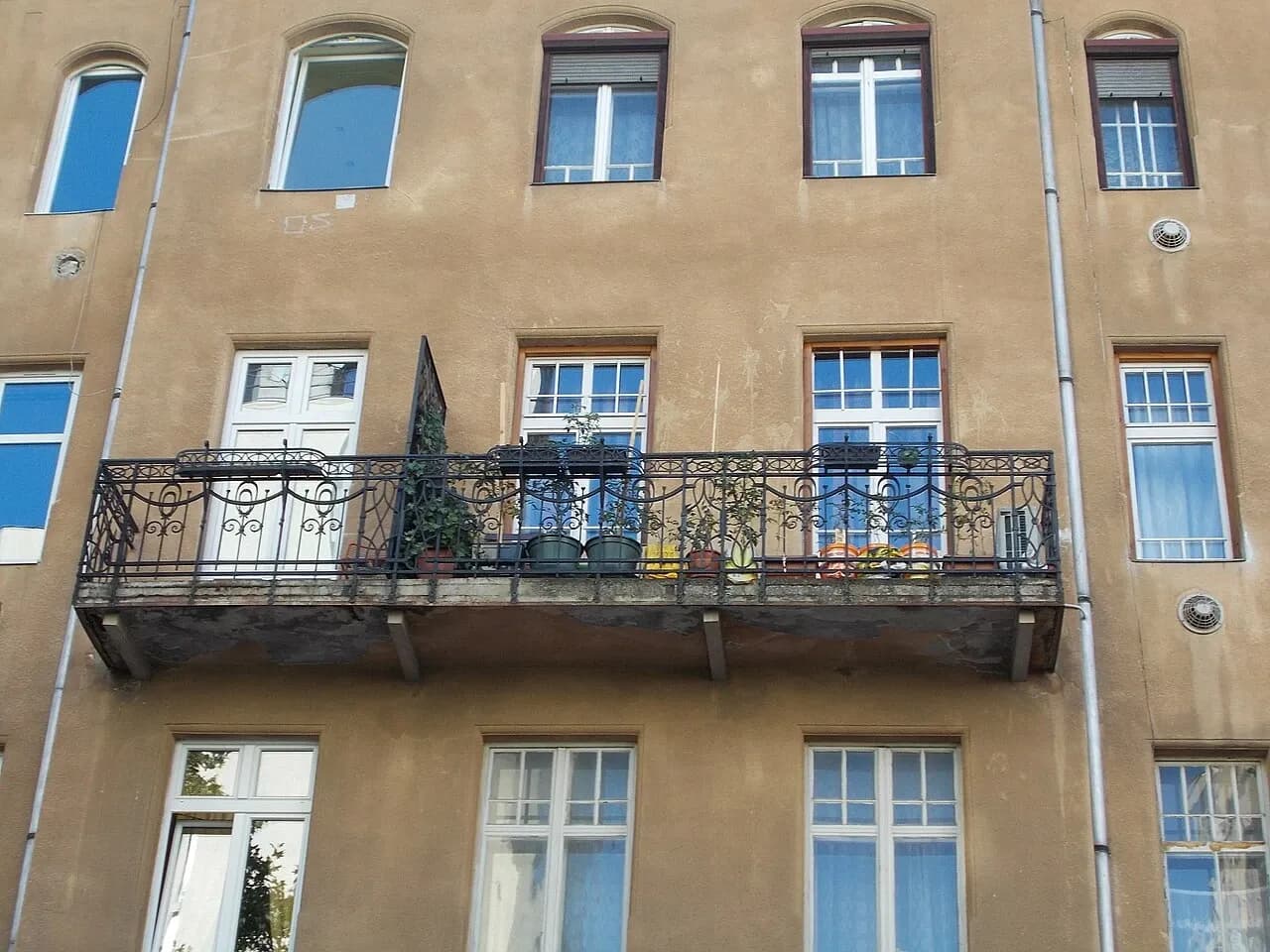 Windows and metal balcony rail on an apartment building in Budapest