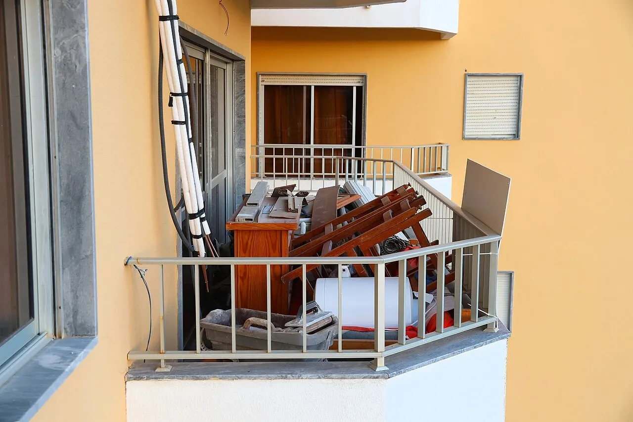 Balcony holding furniture and other items during apartment remodelling in Portugal