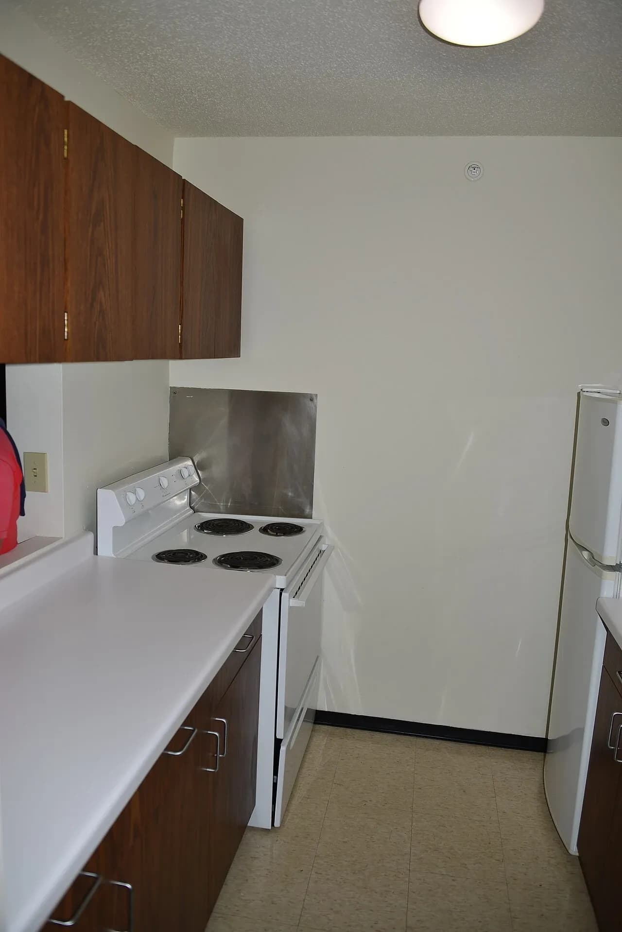 Compact kitchen with cabinets and a refrigerator in a Minneapolis apartment