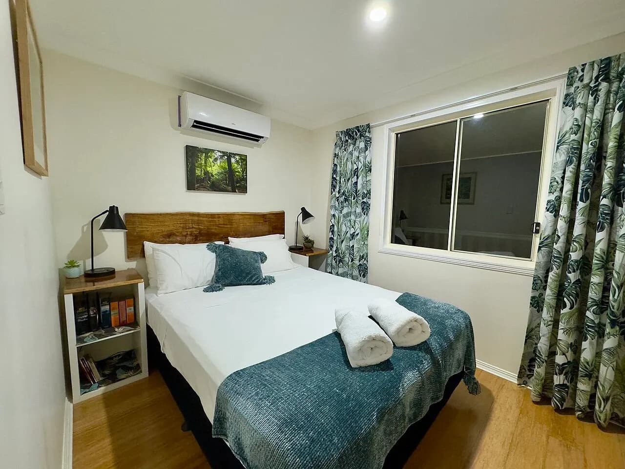 Bedroom with a bed and rolled towels at accommodation in South Mission Beach, Australia