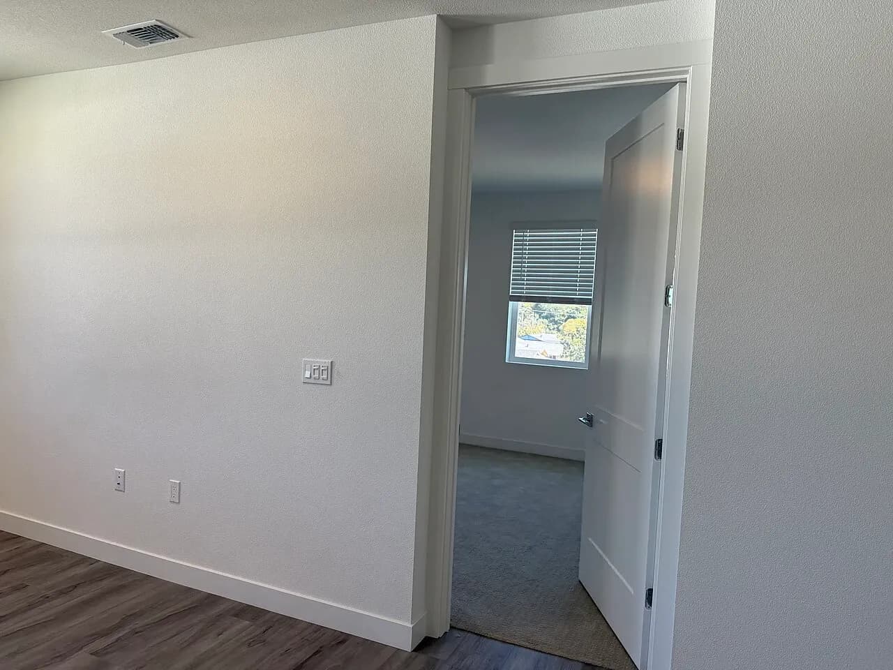 Unfurnished room opening onto an adjoining space