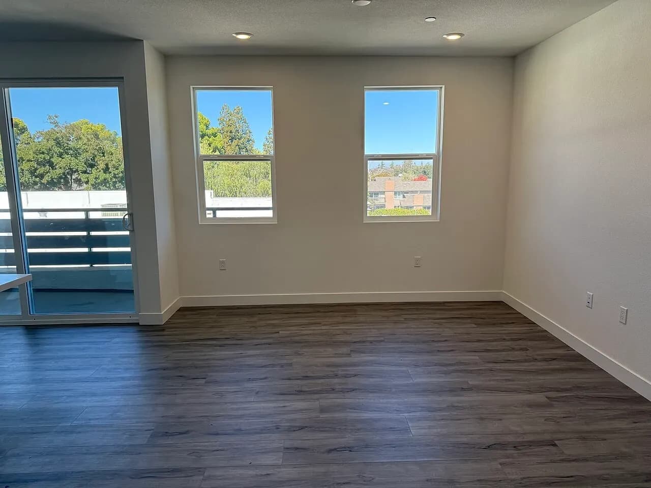 Unfurnished apartment room with windows and an outside door