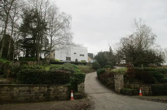 House wrapped for renovation with a driveway approach in Linton, West Yorkshire