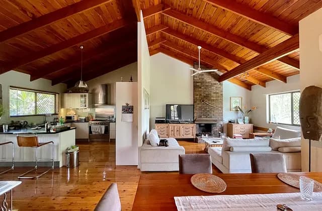 Open kitchen and sitting area with a wooden ceiling in a Corinda house, Australia