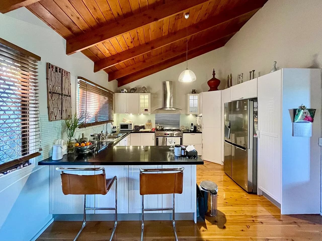 Kitchen counter, stools and cabinets in a Corinda house, Australia