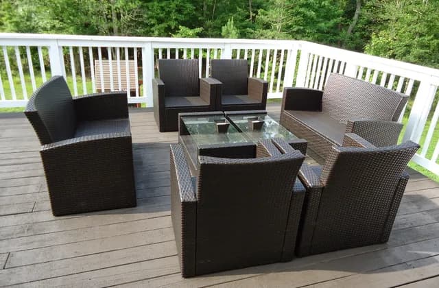 Outdoor chairs and a glass-topped table on a wooden residential deck in Maryland, July 2014