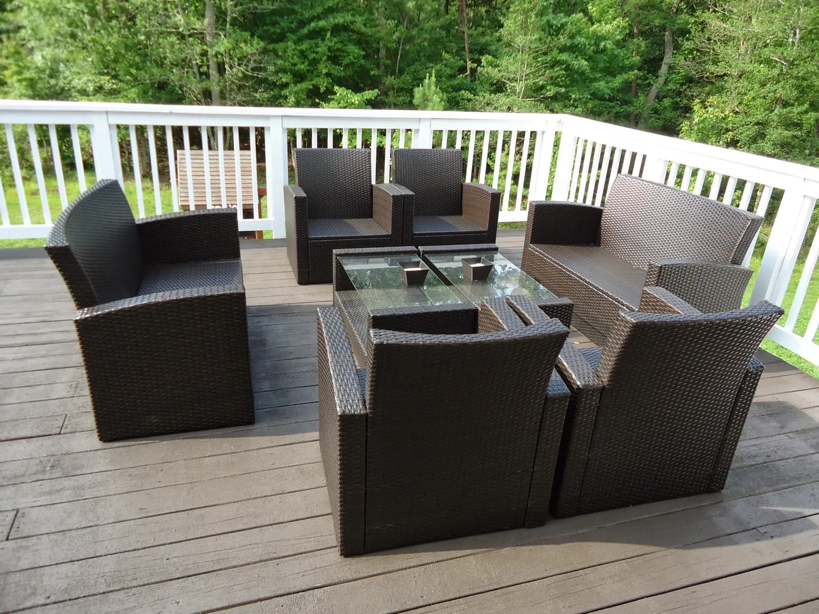 Outdoor chairs and a glass-topped table on a wooden residential deck in Maryland, July 2014