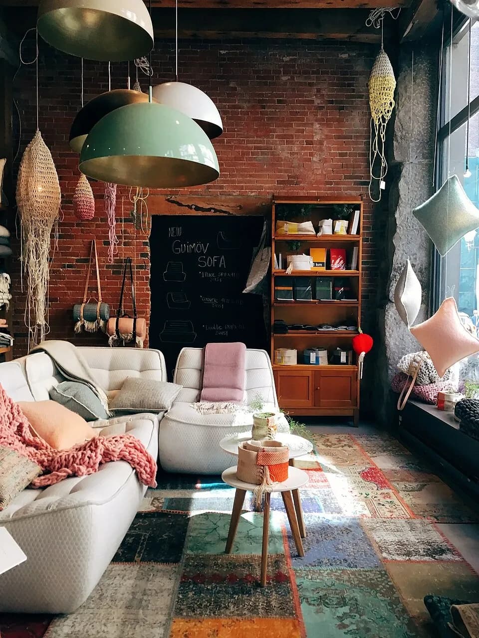 Sunlight across a furnished seating area beside a tall window in Montreal