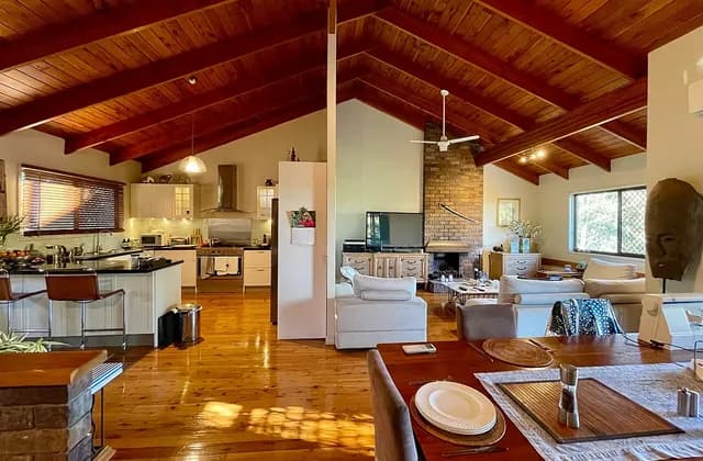 Open-plan kitchen and sitting space with a wooden ceiling in a house in Corinda, Queensland, Australia