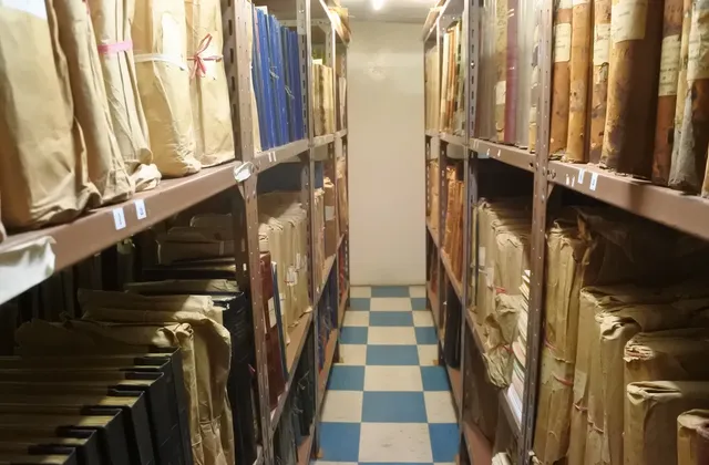 Paper bundles and bound volumes on shelves in St Helena Archives, Jamestown, photographed in March 2018