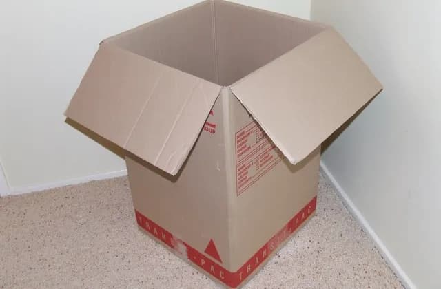 Open cardboard moving box on a carpeted floor, in a photograph attributed to April 2007