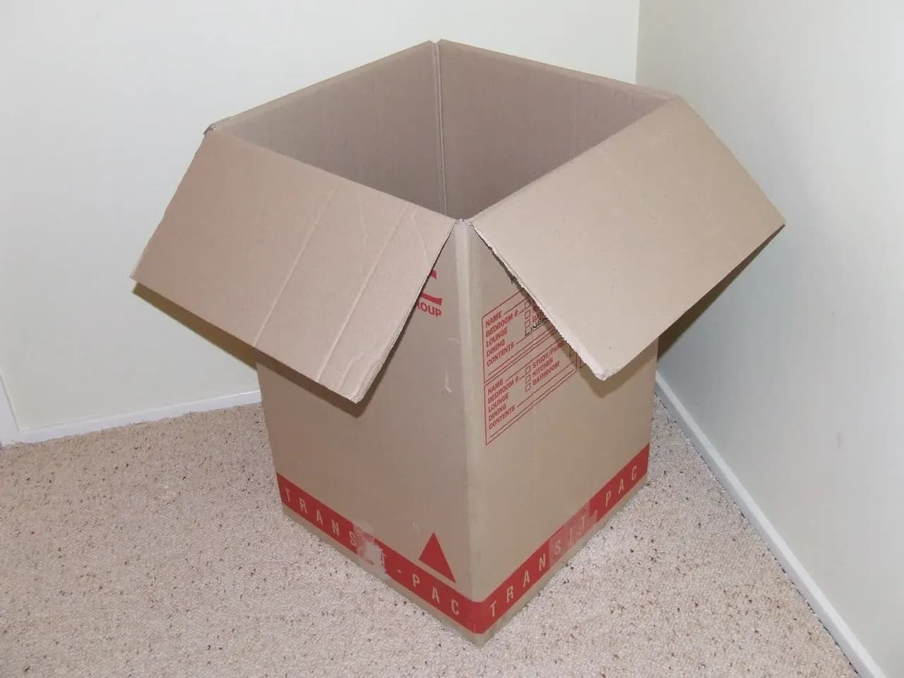 Open cardboard moving box on a carpeted floor, in a photograph attributed to April 2007