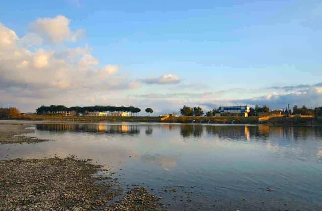 Archive view of the Euphrates near Raqqa with low shoreline and buildings beyond, uploaded in April 2005