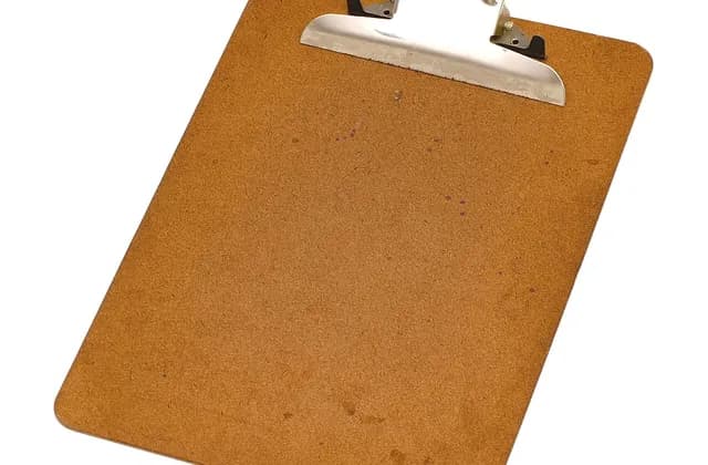 Blank brown clipboard with a metal clip on a white background, in a photograph source-dated August 2010