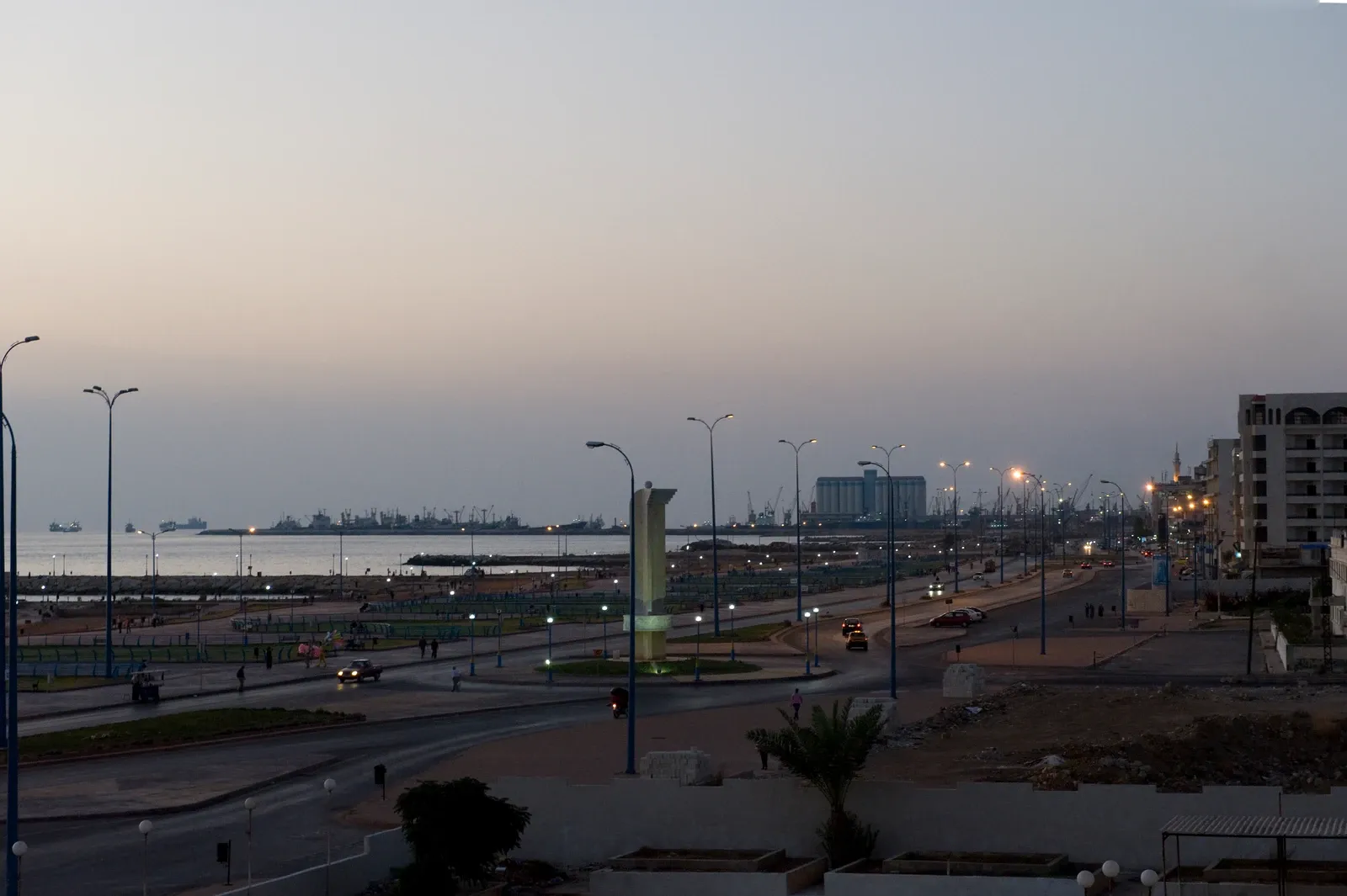 Elevated view along Tartus coastal road with the sea and port structures beyond at dusk, September 2008