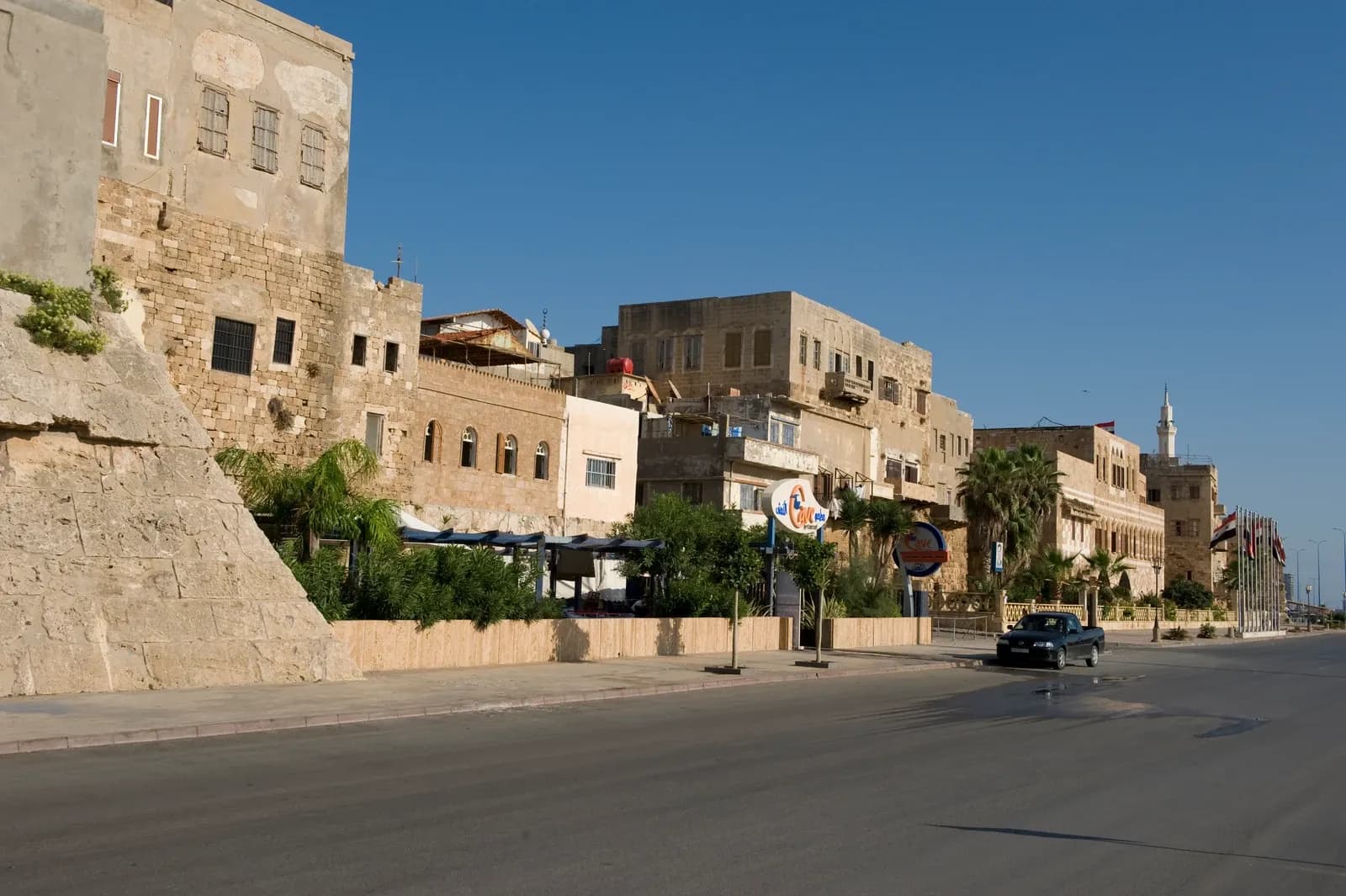 Stone frontage and later buildings beside the road at the seaward side of Tartus citadel, September 2008