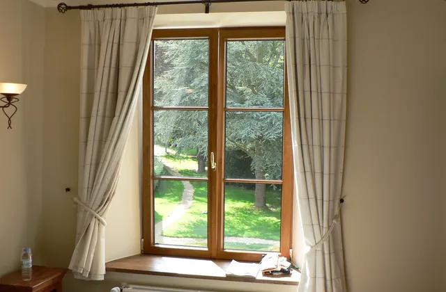 Curtained window above a radiator in an interior in Tellin, Belgium, archive 2005