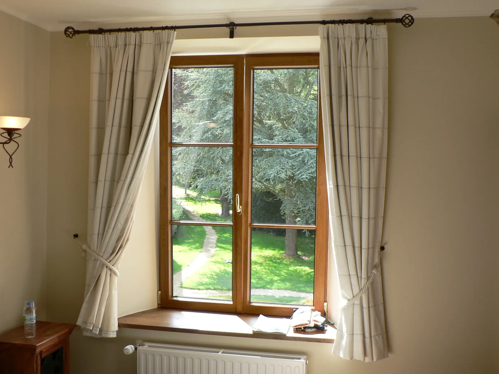 Curtained window above a radiator in an interior in Tellin, Belgium, archive 2005